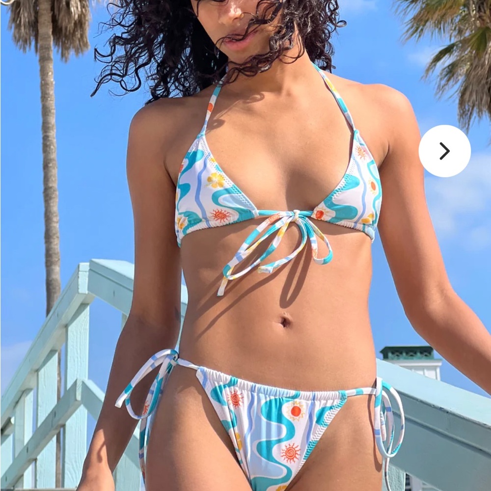 Blue summery patterned adjustable Damson Madder bikini with flowers and suns.